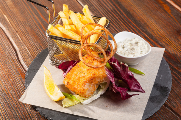 fish with fries and tartar sauce on wooden table - Photo, Image