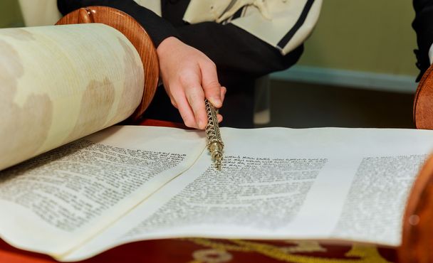 Hand of boy reading the Jewish Torah at Bar Mitzvah - Photo, Image
