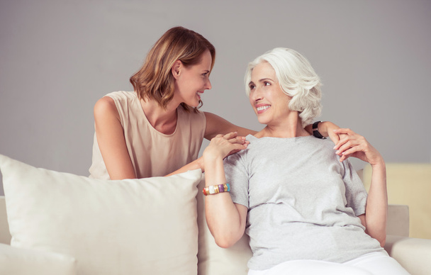 Cheerful delighted mother and her adult daughter resting at home - Photo, Image