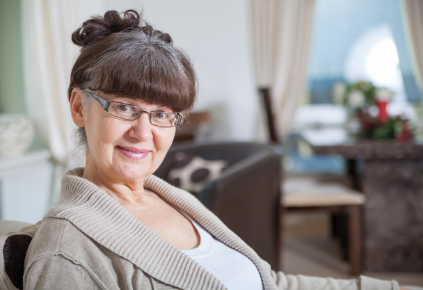 Pension age good looking woman portrait in domestic environment - Foto, afbeelding