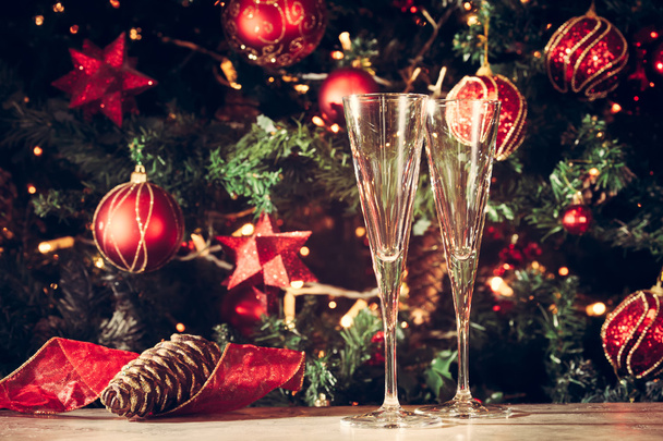 Getting ready! Two empty glasses with Christmas tree background. - Photo, Image