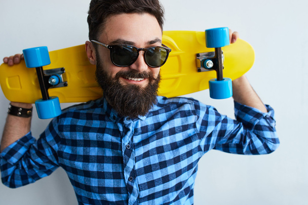 Young man with skateboard - Фото, изображение