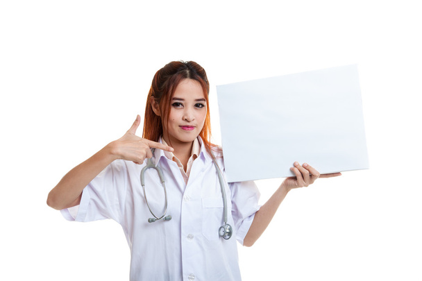 Young Asian female doctor point to a blank sign. - Photo, image