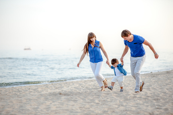 Woman, man and child  on the beach  - Photo, Image