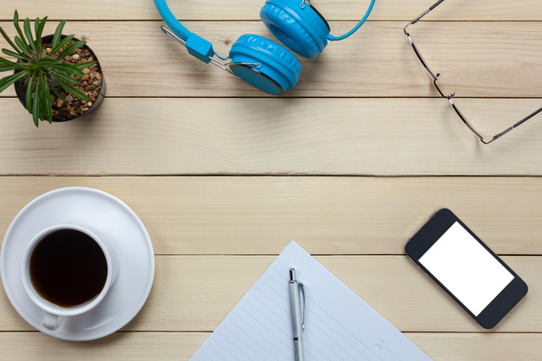 notepaper,headphones,smartphone,pen,coffee ,cactus,eyeglasses on office desk - Photo, Image