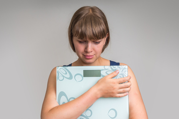 Frustrated overweight woman with scales - Photo, Image