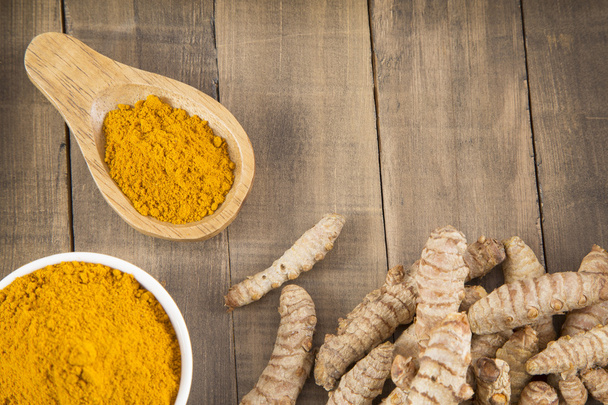 Fresh turmeric roots on wooden table - Photo, Image