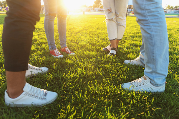 four friends in sneakers outdoors - Photo, image