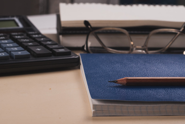 glasses, calculator, Notepad on a white table - Foto, immagini