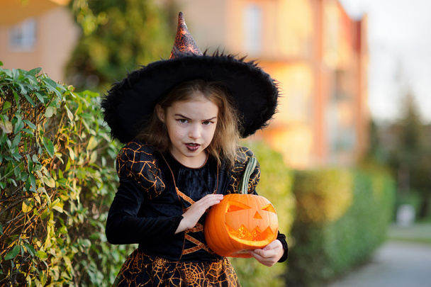 Eve of All Saints' Day. Girl 8-9 years portrays the evil enchantress. - Photo, Image