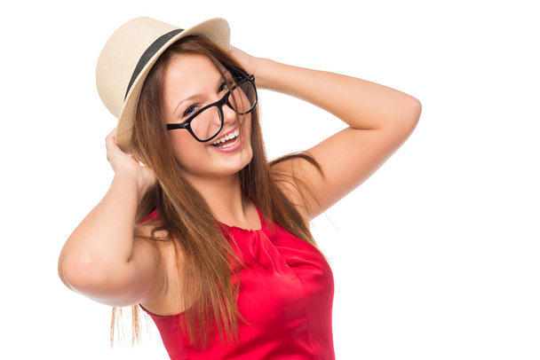 cheerful girl in a hat and glasses isolated in the studio - Фото, изображение