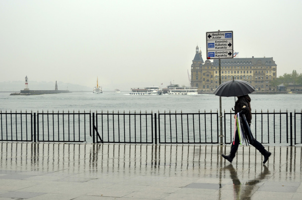 Istanbul steamboat pier people walking in the rain. - Photo, Image