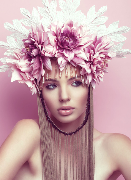 Beautiful woman with flower crown and makeup on pink background - Foto, imagen