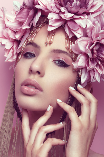 Beautiful woman with flower crown and makeup on pink background - 写真・画像