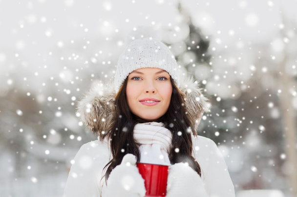 happy young woman with tea cup outdoors in winter - Foto, Imagem