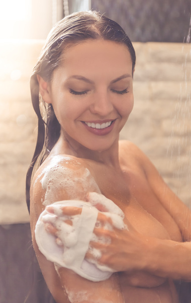 Beautiful woman taking shower - 写真・画像