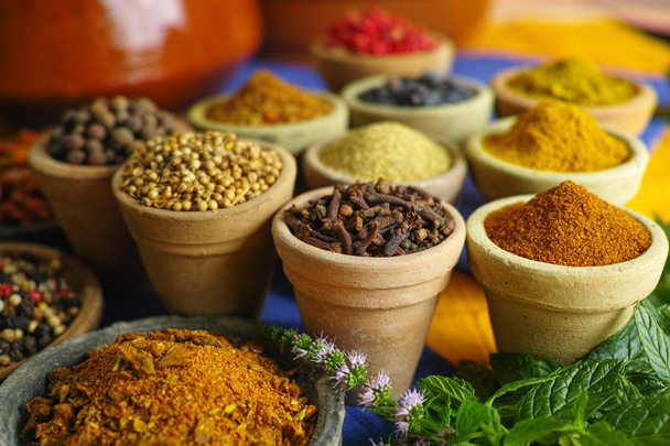 Collection of different spices in old clay bowls in colorful ori - Photo, Image