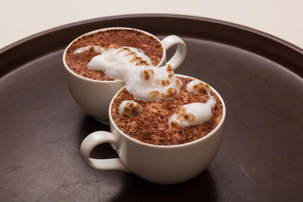 Coffee with foam in the form of a cat and a mouse on brown table - Photo, Image