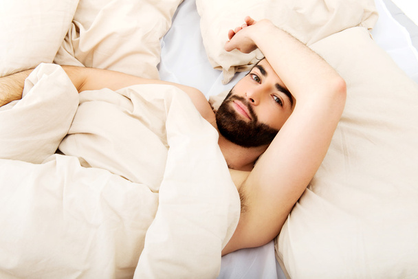 Young man lying in bed. - Fotoğraf, Görsel