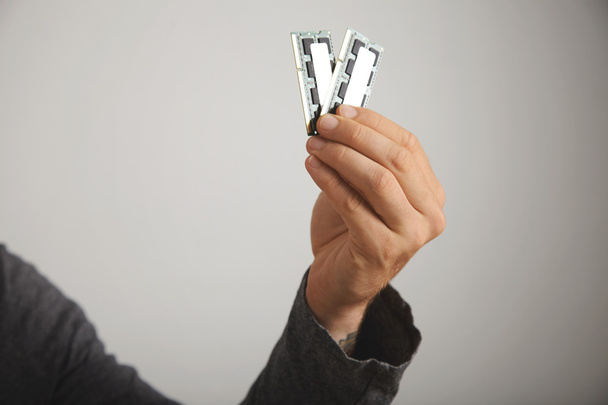 Man's hand holding memory chips - Фото, изображение