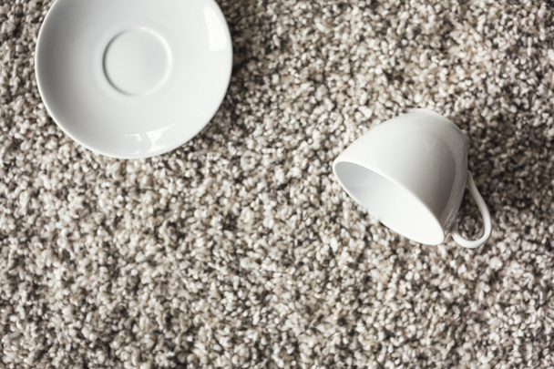 Copa y platillo en el suelo de la alfombra
 - Foto, Imagen