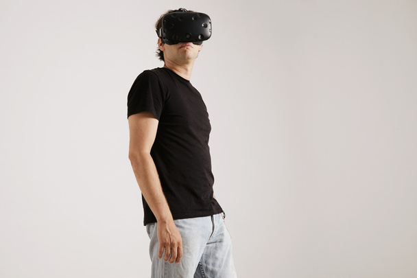 Man wearing VR glasses and looking around  - Fotó, kép