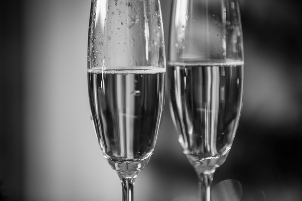 Macro black and white shot of champagne bubbles in two glasses - Photo, Image