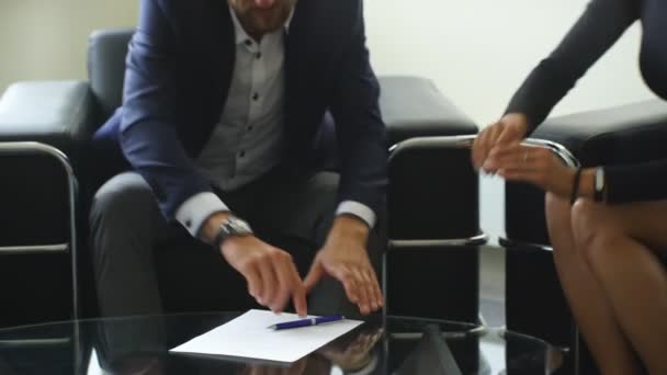Young couple signing renting contract with real estate agent - Video