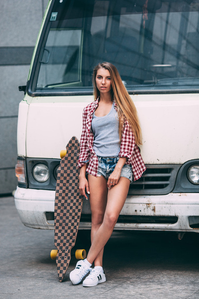 young beautiful woman with longboard - Фото, изображение