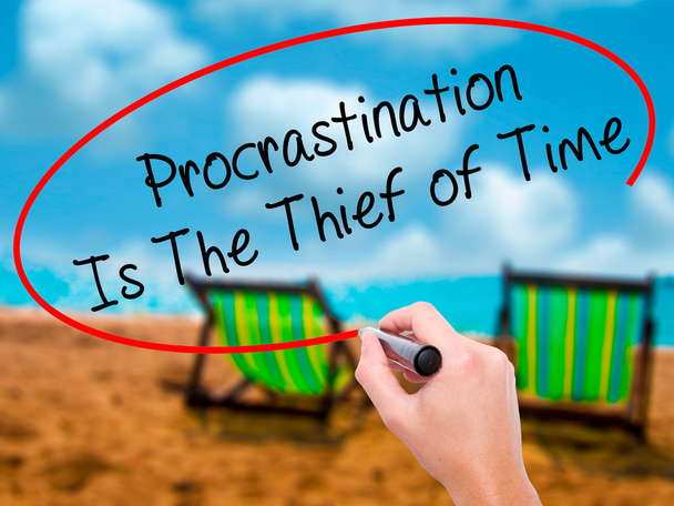 Man Hand writing  Procrastination Is The Thief of Time with blac - Photo, Image