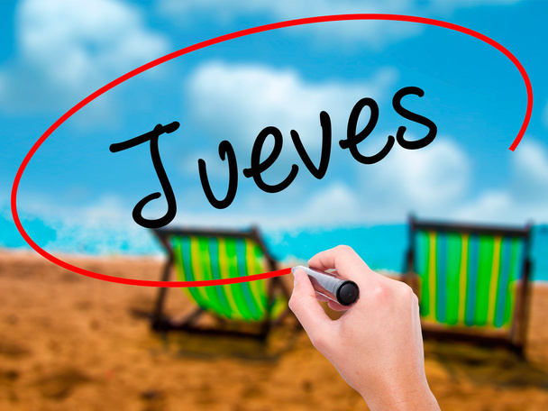 Людина почерком Jueves (четвер по-іспанськи) з чорний маркер  - Фото, зображення