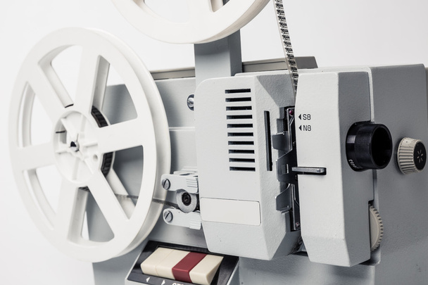 Old film projector isolated on a white background - Φωτογραφία, εικόνα
