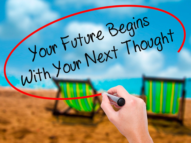 Man Hand writing Your Future Begins With Your Next Thought with  - Photo, Image