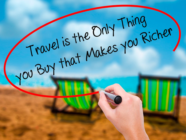 Man Hand writing Travel is the Only Thing you Buy that Makes you - Фото, зображення
