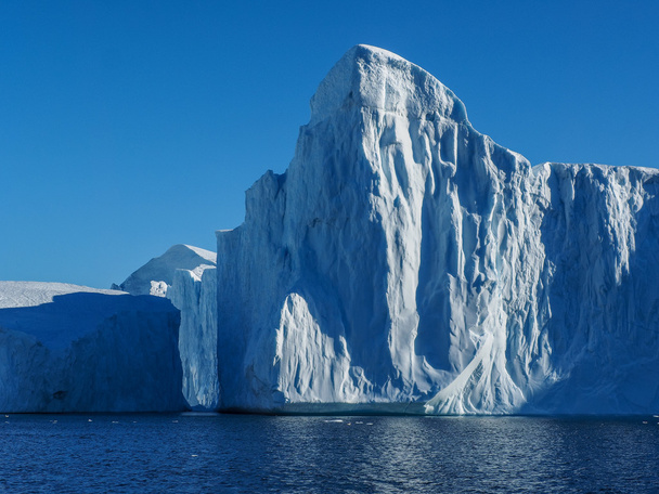 valtava jäävuori vedessä
 - Valokuva, kuva