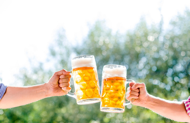 Hands of two men holding beer - Φωτογραφία, εικόνα