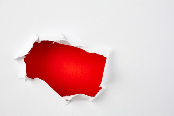 Red hole in torn paper - Fotografie, Obrázek