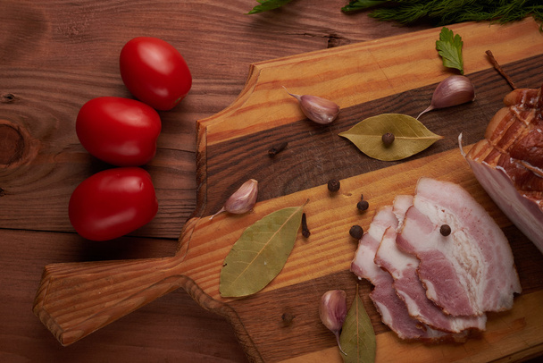 bacon and seasonings on a wooden table - Foto, imagen