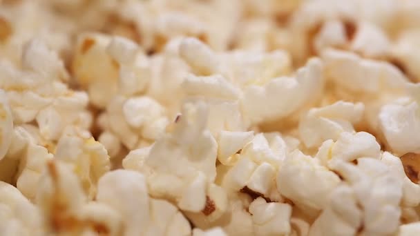Heap of popcorn in rotation, salty or sweet snack, movie theatre entertainment - Video, Çekim