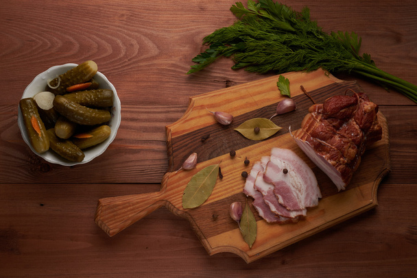 bacon and seasonings on a wooden table - Фото, зображення