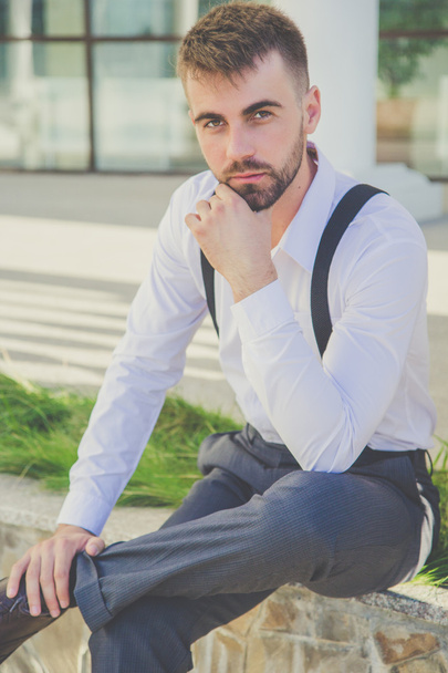 Stylish man with beard is wearing suspenders - Фото, зображення