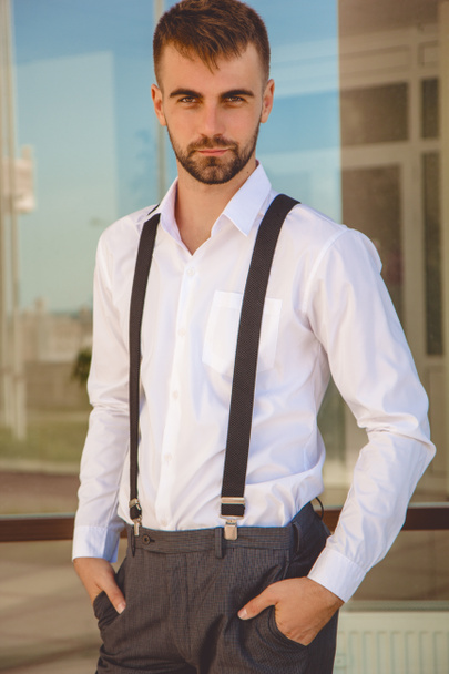 Handsome man with beard is wearing suspenders - Valokuva, kuva