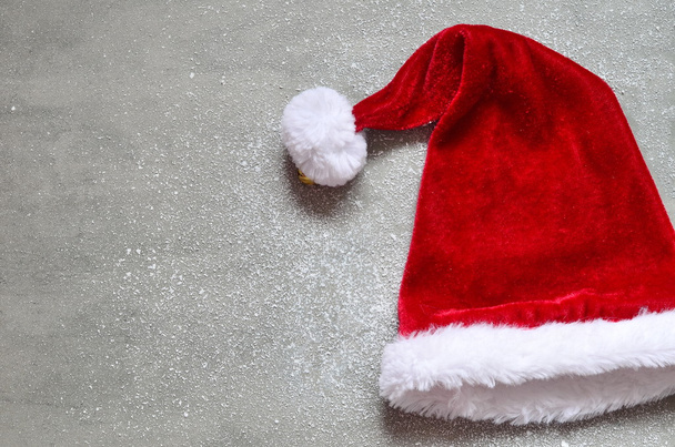 Christmas grey background with Santa hat. - Photo, Image