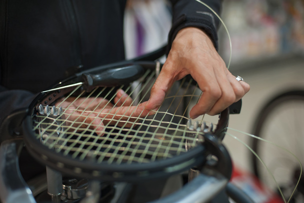 Close up of tennis stringer hands doing racket stringing - Foto, immagini