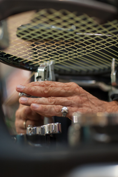 Close up of tennis stringer hands doing racket stringing - Photo, Image