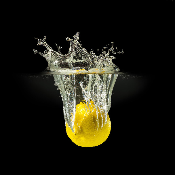 Fresh fruits falling in water with splash on black background - Foto, immagini