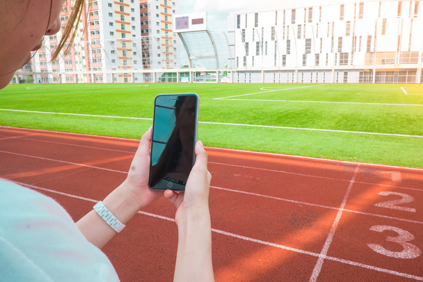 detail of people using smartphone in the soccer stadium - Fotografie, Obrázek
