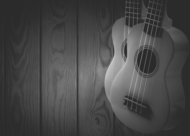 Part of an acoustic guitar on a gray wooden background. - Photo, Image