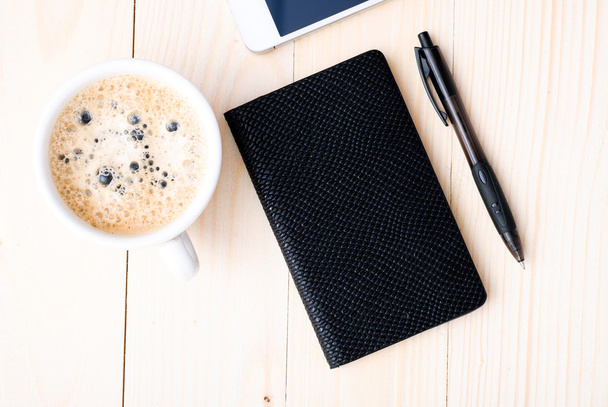 Smartphone with notebook and cup of strong coffee - Fotó, kép