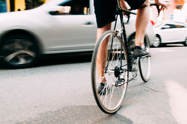Man start riding on bicycle in city - Foto, Imagen
